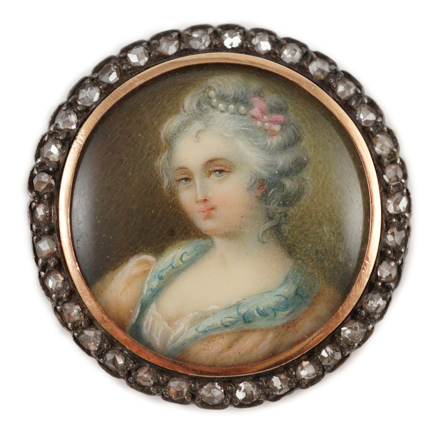 An Edwardian diamond set circular gold brooch with inset miniature portrait bust of a lady